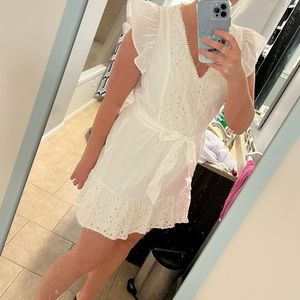 A white dress that is perfect for a bridal shower or wedding rehearsal dinner.